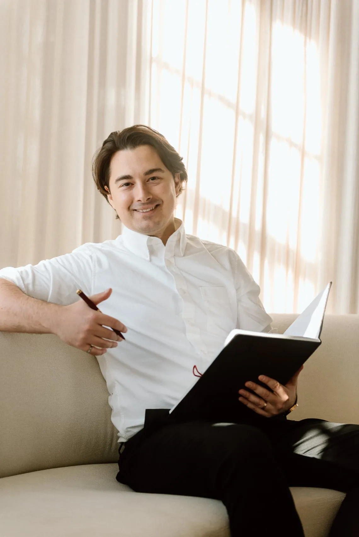 Vitalijs writing ideas in a notebook